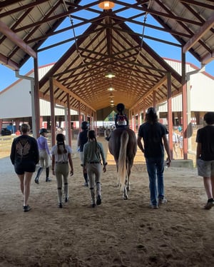 Staff wtih smallest rider at a show_PC Cynthia Soueidan